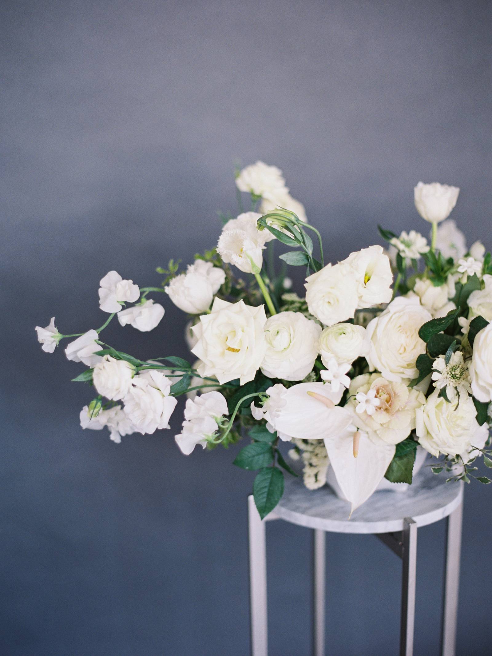 Fine Art Colorado Wedding Photography worked with Emma Lea Floral to capture this beautiful minimalist all white wedding arrangement 