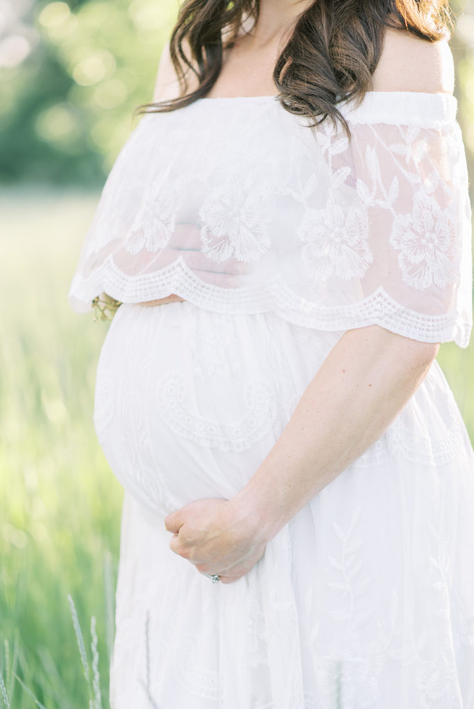 mama holding her baby belly during her Littleton maternity session
