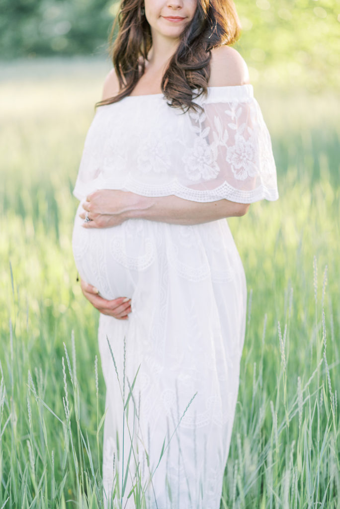 mama holding her belly during her Littleton maternity session