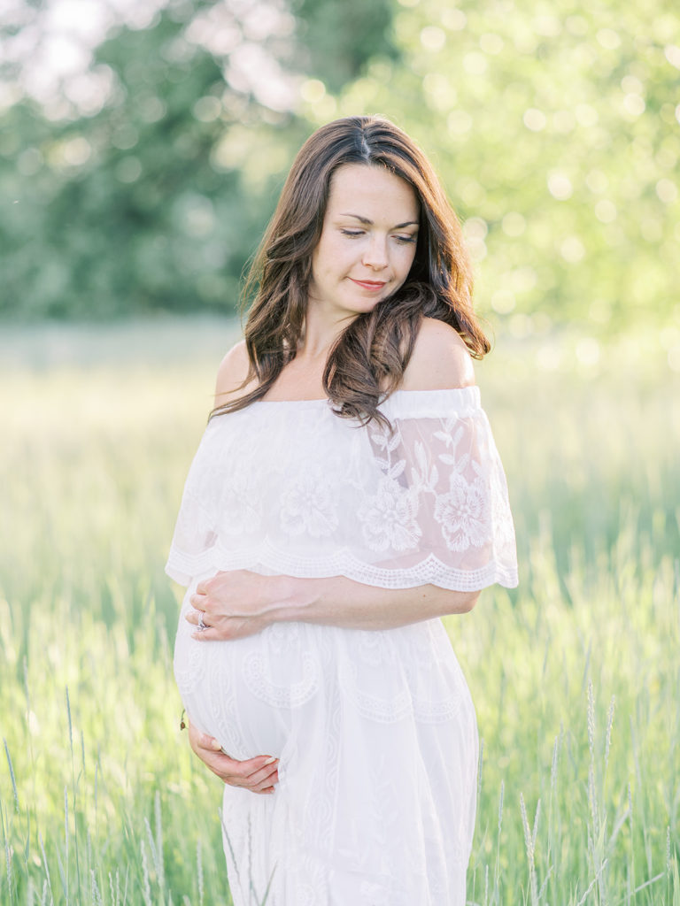 beautiful mom holding baby belly during their Littleton maternity session