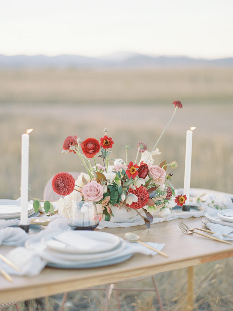 Close up of a centerpiece designed by Helios Floral during a Romantic Al Fresco Wedding Inspiration at Stonewall Farm